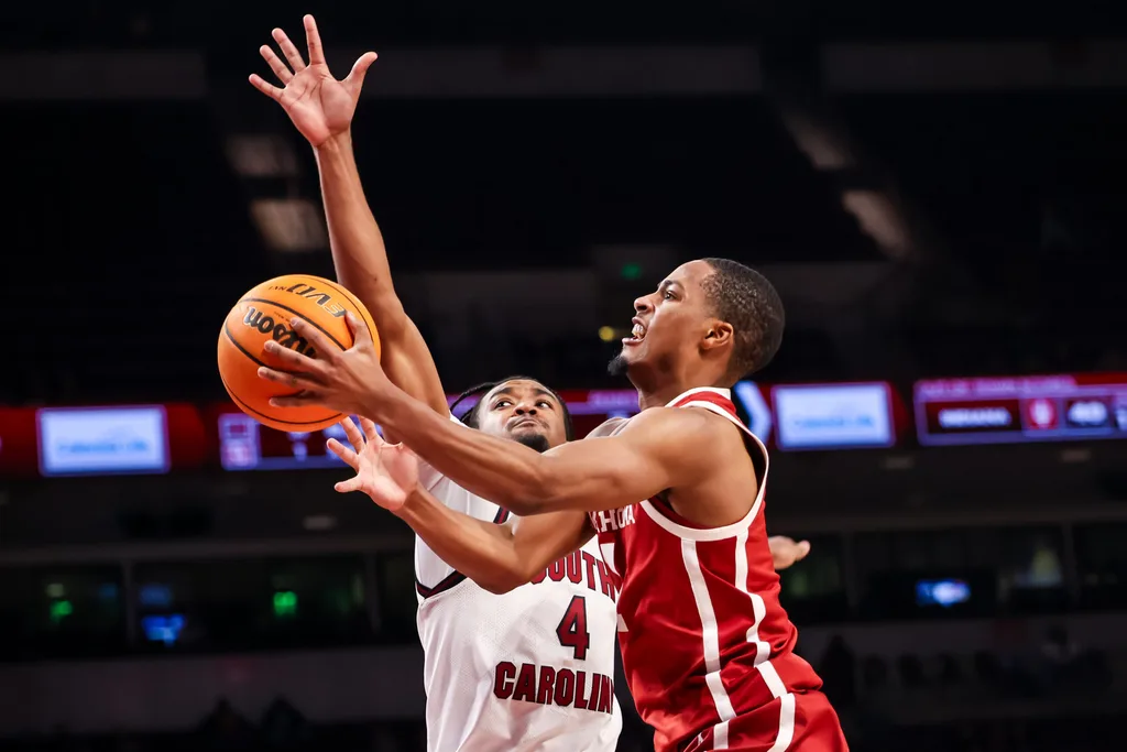 Jan 20, 2026; Columbia, South Carolina, USA; Oklahoma Sooners guard Xzayvier Brown (1) drives past South Carolina Gamecocks guard Kobe Knox (4) in the second half at Colonial Life Arena. Mandatory Credit: Jeff Blake-Imagn Images