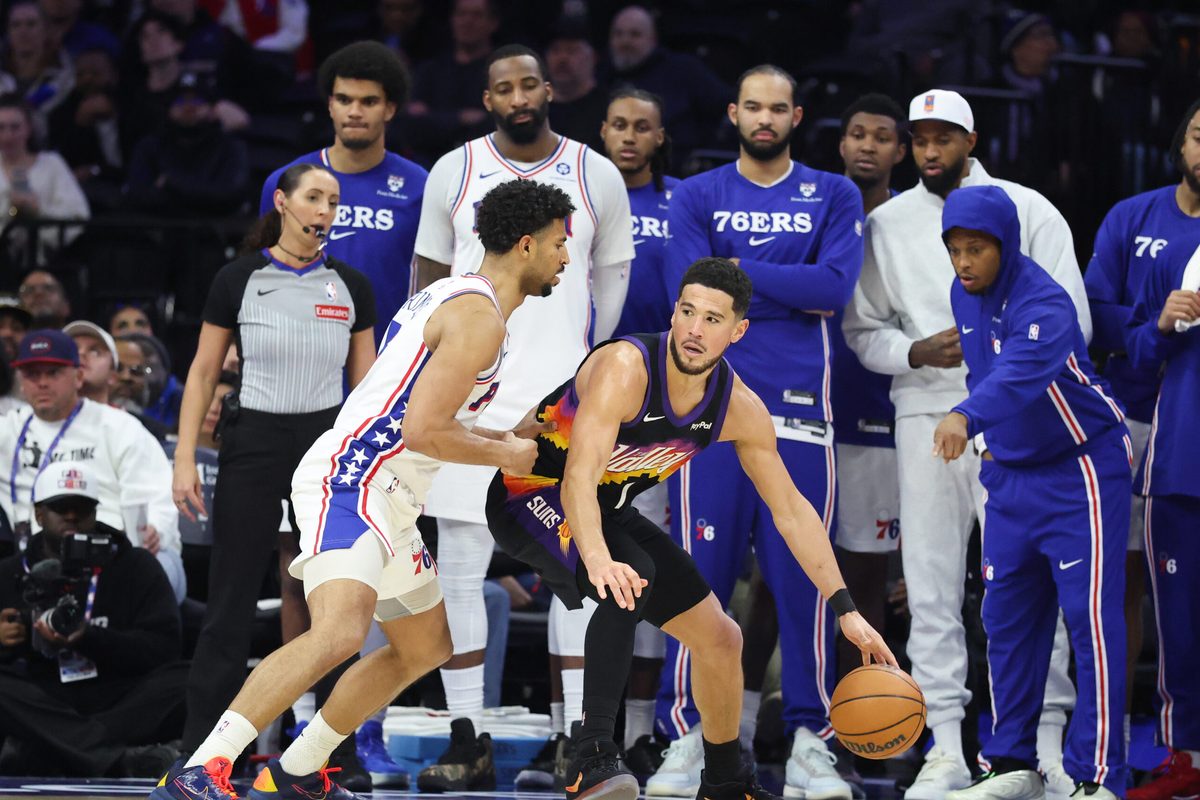 Jan 20, 2026; Philadelphia, Pennsylvania, USA; Phoenix Suns guard Devin Booker (1) dribbles the ball against Philadelphia 76ers guard Quentin Grimes (5) during the fourth quarter at Xfinity Mobile Arena. Mandatory Credit: Bill Streicher-Imagn Images