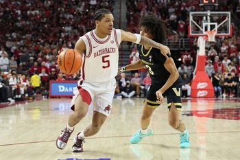Jan 20, 2026; Fayetteville, Arkansas, USA; Arkansas Razorbacks guard Darius Acuff Jr (5) drives against Vanderbilt Commodores guard Tyler Tanner (3) during the first half against at Bud Walton Arena. Mandatory Credit: Nelson Chenault-Imagn Images