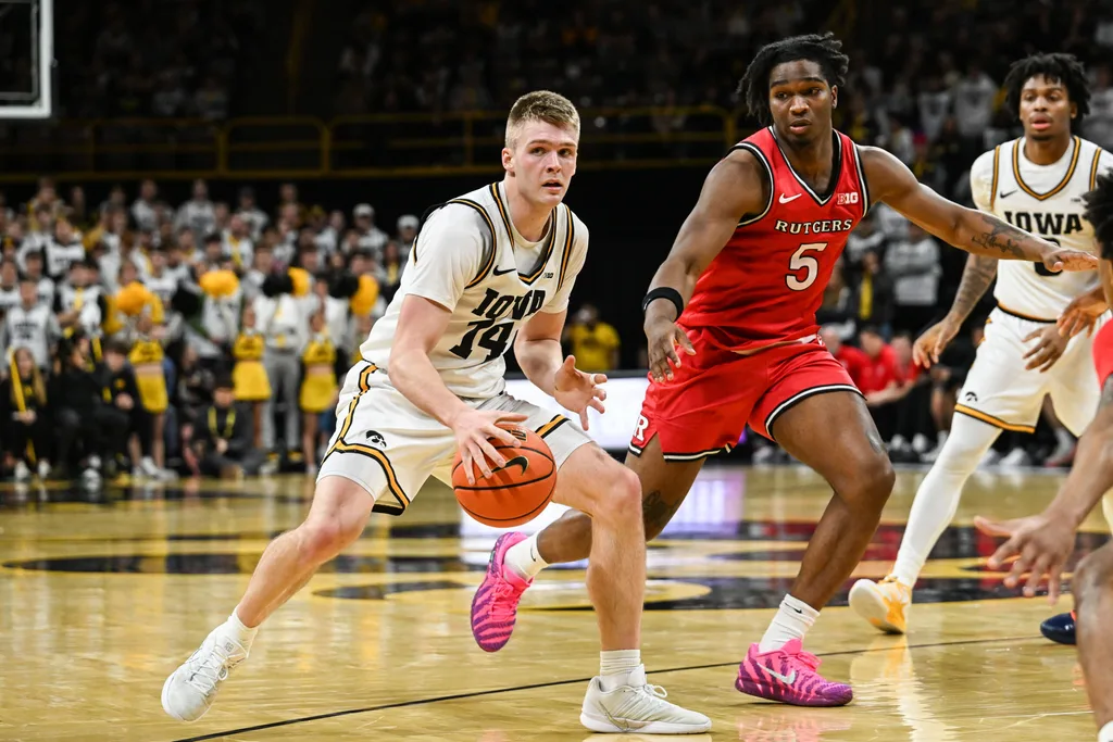 Jan 20, 2026; Iowa City, Iowa, USA; Iowa Hawkeyes guard Bennett Stirtz (14) controls the ball as Rutgers Scarlet Knights guard Darren Buchanan Jr. (5) defends during the 2nd half at Carver-Hawkeye Arena. Mandatory Credit: Jeffrey Becker-Imagn Images