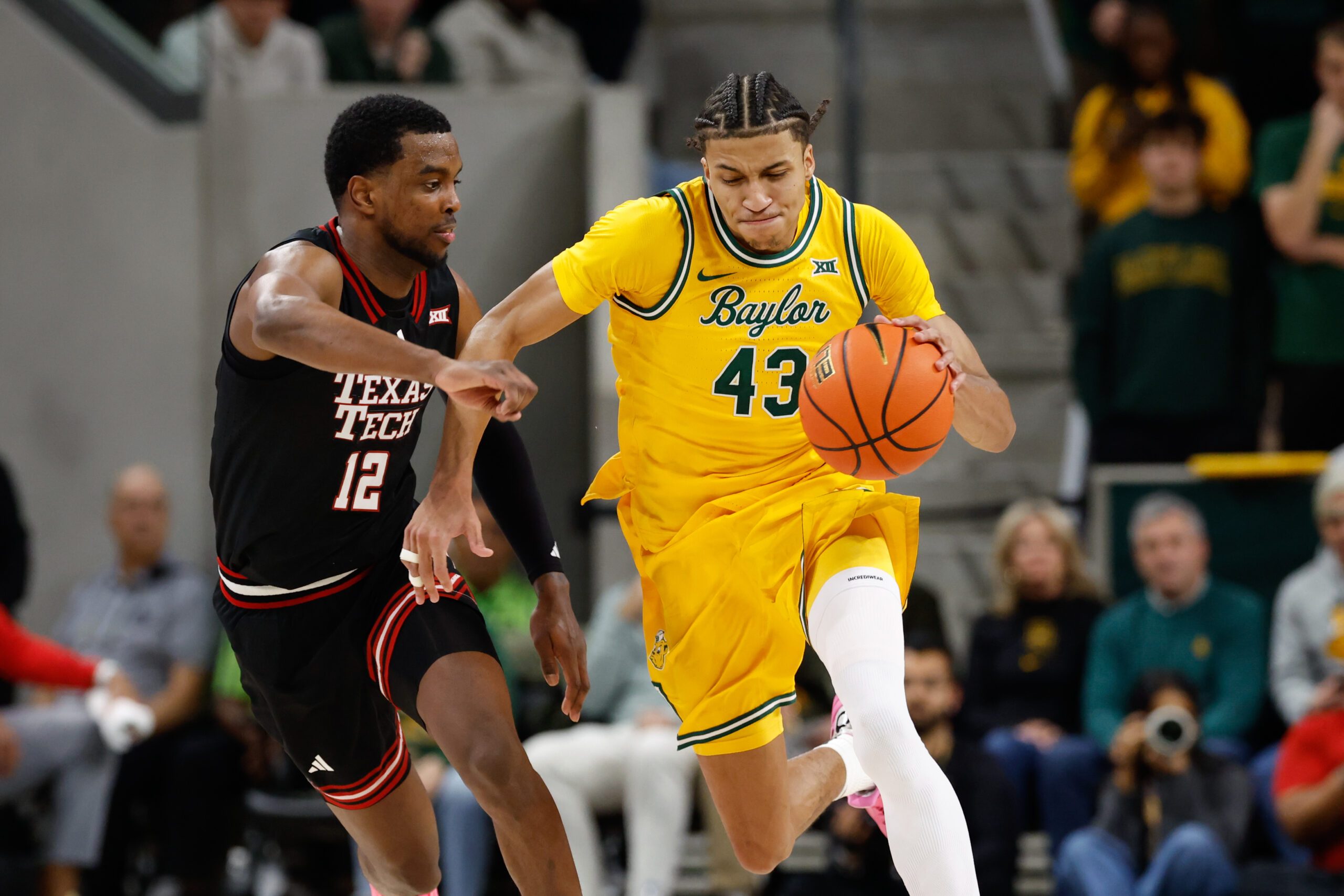 Jan 20, 2026; Waco, Texas, USA;  Baylor Bears guard Cameron Carr (43) dribbles the ball upcourt against Texas Tech Red Raiders forward Donovan Atwell (12) during the second half at Paul and Alejandra Foster Pavilion. Mandatory Credit: Chris Jones-Imagn Images