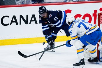 Jan 20, 2026; Winnipeg, Manitoba, CAN; Winnipeg Jets forward Mark Scheifele (55) and St. Louis Blues defenseman Tyler Tucker (75) contest for the puck during the third period at Canada Life Centre. Mandatory Credit: Terrence Lee-Imagn Images