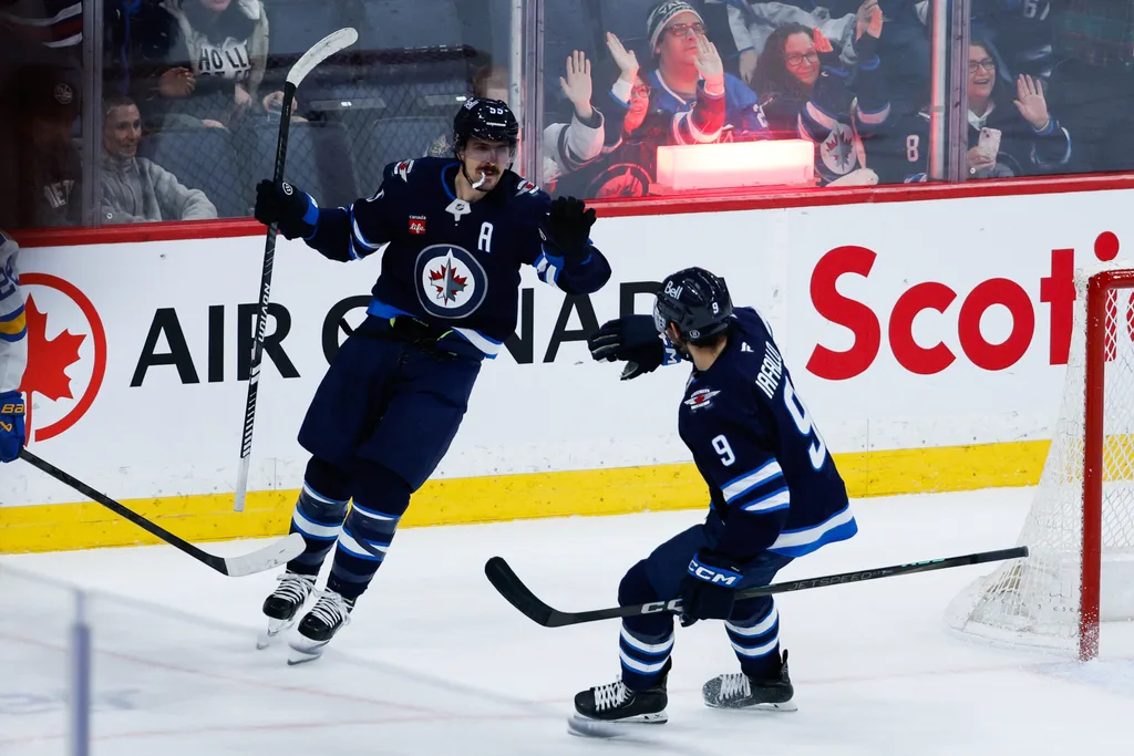 Jan 20, 2026; Winnipeg, Manitoba, CAN; Winnipeg Jets forward Mark Scheifele (55) is congratulated by Winnipeg Jets forward Kyle Connor (81) on his goal against the St. Louis Blues during the third period at Canada Life Centre. Mandatory Credit: Terrence Lee-Imagn Images
