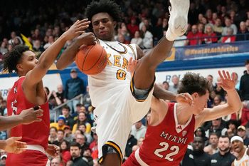 Kent State’s Rayvon Griffith pulls down a rebound as Miami’s Eian Elmer and Brant Byers defend during the game at the MAC Center in Kent on Jan. 20, 2026.