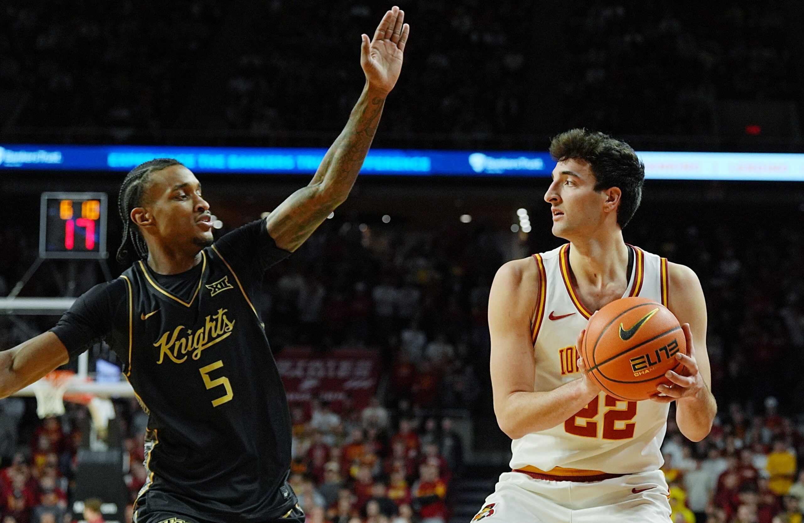 Iowa State Cyclones forward Milan Momcilovic (22) looks for pass around UCF Knights guard Kris Parker (5) during the first half in the Big-12 conference men’s basketball on Jan. 20, 2026, at Hilton Coliseum in Ames, Iowa.