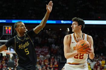Iowa State Cyclones forward Milan Momcilovic (22) looks for pass around UCF Knights guard Kris Parker (5) during the first half in the Big-12 conference men’s basketball on Jan. 20, 2026, at Hilton Coliseum in Ames, Iowa.