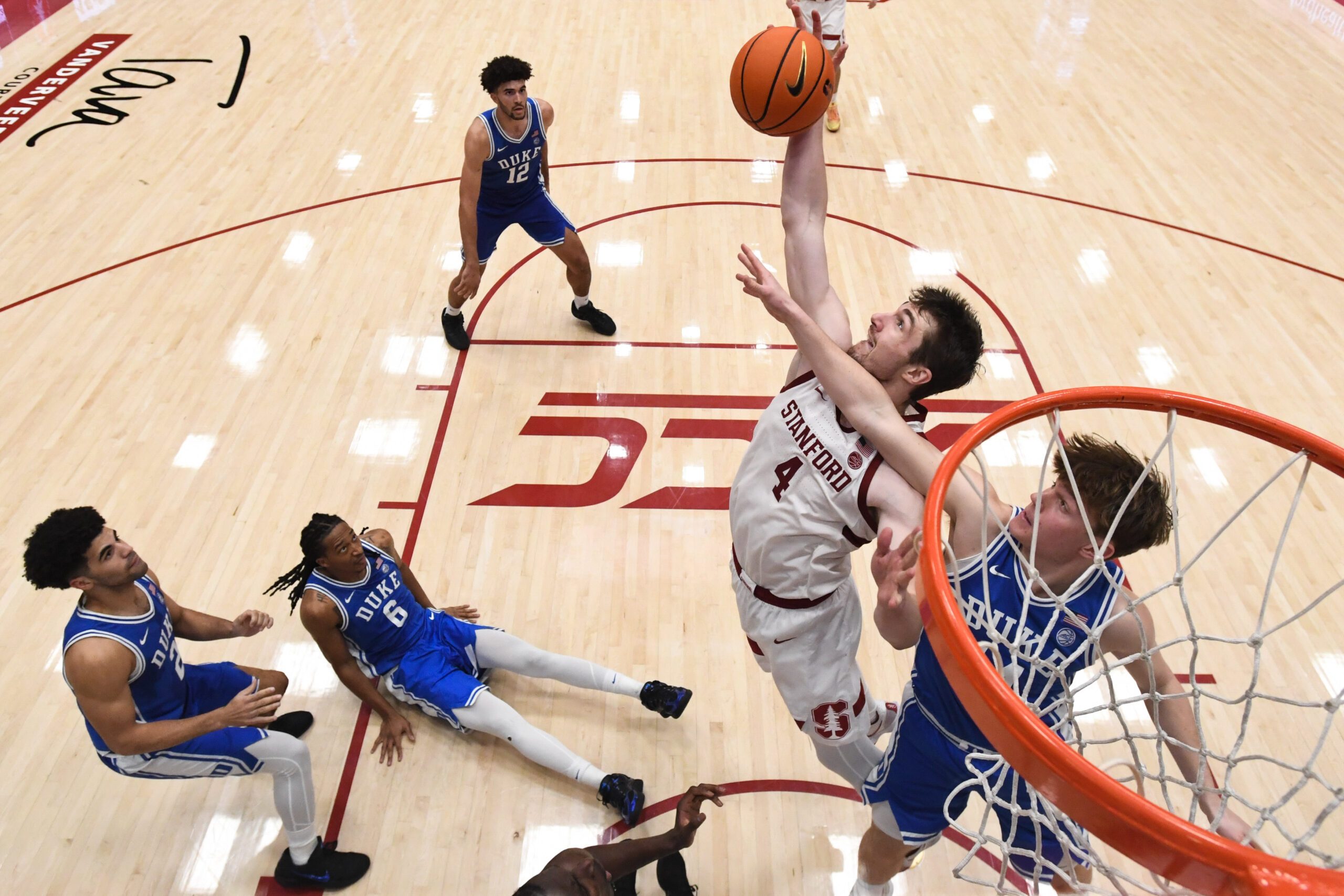 Jan 17, 2026; Stanford, California, USA; Stanford Cardinal forward AJ Rohosy (4) rebounds against Duke Blue Devils guard Nikolas Khamenia (14) in the second half at Maples Pavilion. Mandatory Credit: Eakin Howard-Imagn Images