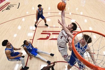 Jan 17, 2026; Stanford, California, USA; Stanford Cardinal forward AJ Rohosy (4) rebounds against Duke Blue Devils guard Nikolas Khamenia (14) in the second half at Maples Pavilion. Mandatory Credit: Eakin Howard-Imagn Images