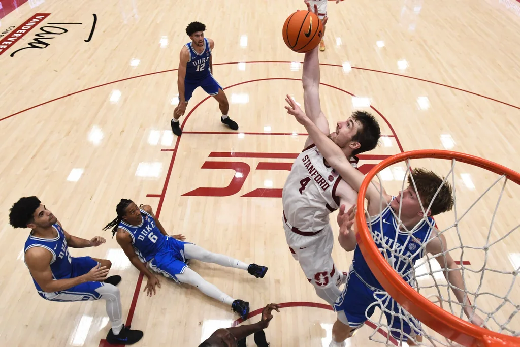 Jan 17, 2026; Stanford, California, USA; Stanford Cardinal forward AJ Rohosy (4) rebounds against Duke Blue Devils guard Nikolas Khamenia (14) in the second half at Maples Pavilion. Mandatory Credit: Eakin Howard-Imagn Images