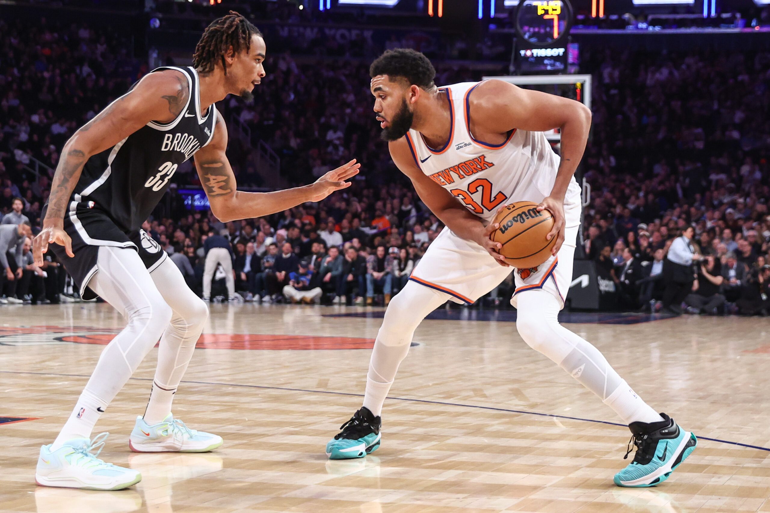 Jan 21, 2026; New York, New York, USA;  New York Knicks center Karl-Anthony Towns (32) looks to drive past Brooklyn Nets center Nic Claxton (33) in the second quarter at Madison Square Garden. Mandatory Credit: Wendell Cruz-Imagn Images
