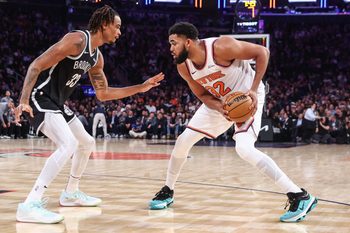 Jan 21, 2026; New York, New York, USA;  New York Knicks center Karl-Anthony Towns (32) looks to drive past Brooklyn Nets center Nic Claxton (33) in the second quarter at Madison Square Garden. Mandatory Credit: Wendell Cruz-Imagn Images