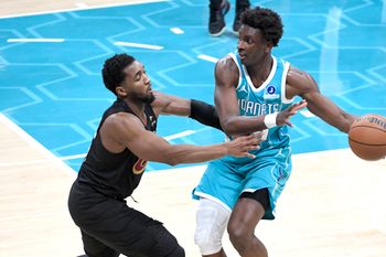 Jan 21, 2026; Charlotte, North Carolina, USA;  Charlotte Hornets center Moussa Diabate (14) takes the ball from Cleveland Cavaliers guard Donovan Mitchell (45) during the second half at the Spectrum Center. Mandatory Credit: Sam Sharpe-Imagn Images