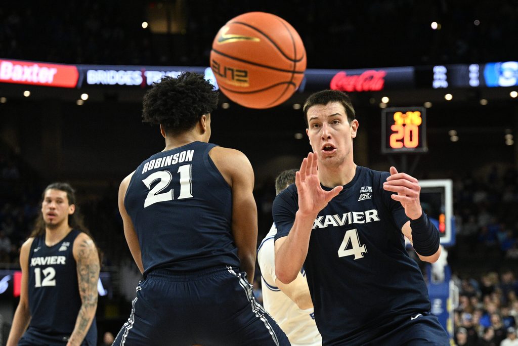 Jan 21, 2026; Omaha, Nebraska, USA; Xavier Musketeers forward Filip Borovicanin (4) receives an inbound pass against the Creighton Bluejays during the first half at CHI Health Center Omaha. Mandatory Credit: Steven Branscombe-Imagn Images