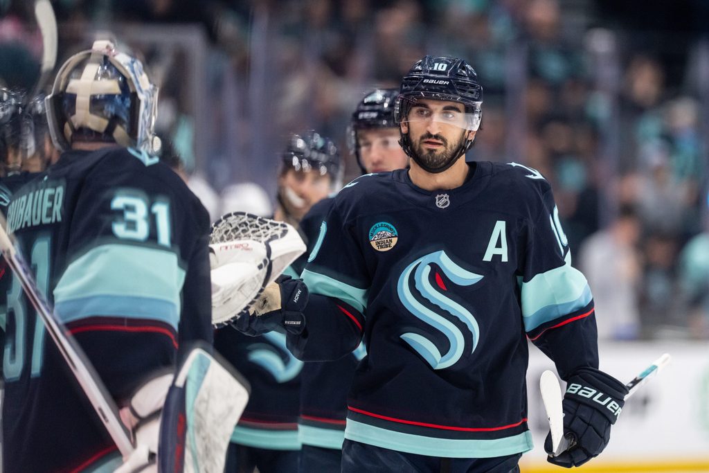 Jan 21, 2026; Seattle, Washington, USA; Seattle Kraken forward Matty Beniers (10) is congratulated by teammates on the bench after scoring a goal during the first period against the New York Islanders at Climate Pledge Arena. Mandatory Credit: Stephen Brashear-Imagn Images
