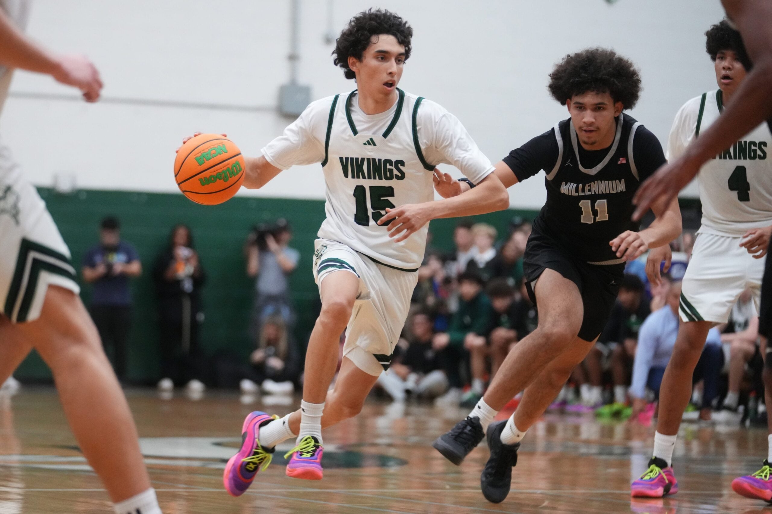 Sunnyslope Vikings guard Rider Portela (15) drives past Millennium Tigers forward DJ Spencer (11) during their game at Sunnyslope High School on Jan. 21, 2026.