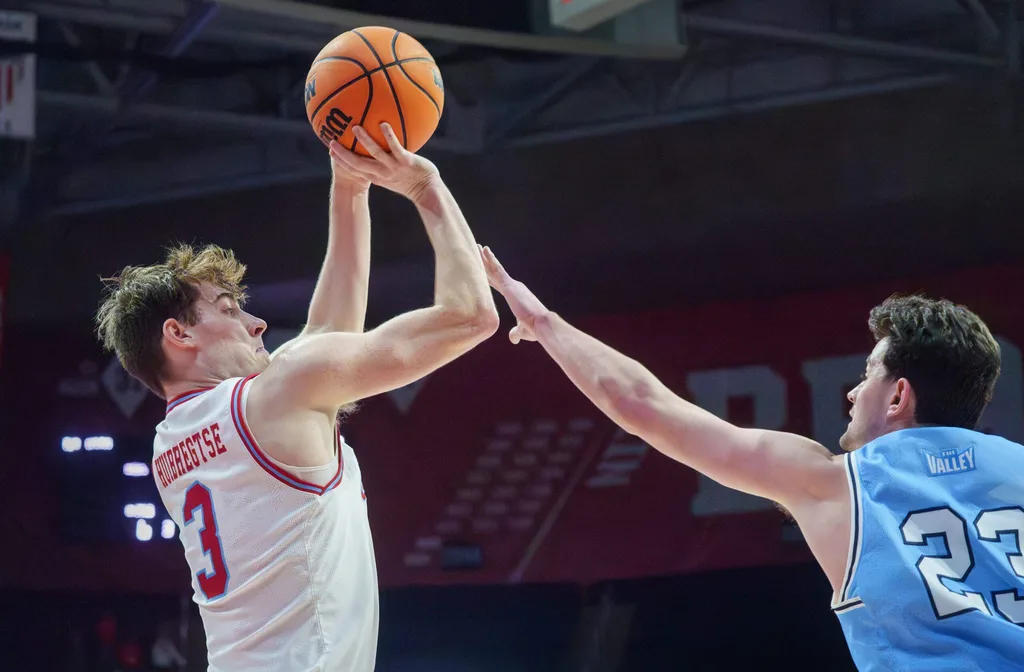 Bradley’s Alex Huibretgse, left, puts up a shot over Indiana State’s Ian Scott in the second half of their college basketball game Wednesday, Jan. 21, 2026 at Carver Arena. The Braves mounted a last-minute rally to defeat the Sycamores 75-68.
