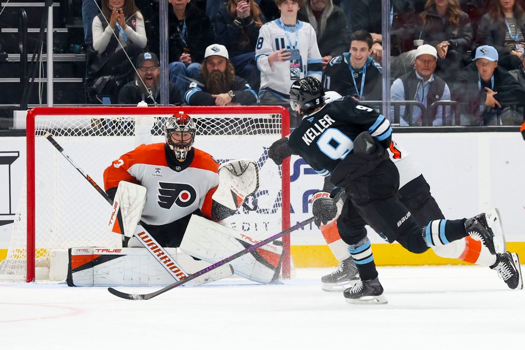 Jan 21, 2026; Salt Lake City, Utah, USA; Utah Mammoth right wing Clayton Keller (9) scores a goal against Philadelphia Flyers goaltender Samuel Ersson (33) to win the game in overtime at Delta Center. Mandatory Credit: Rob Gray-Imagn Images