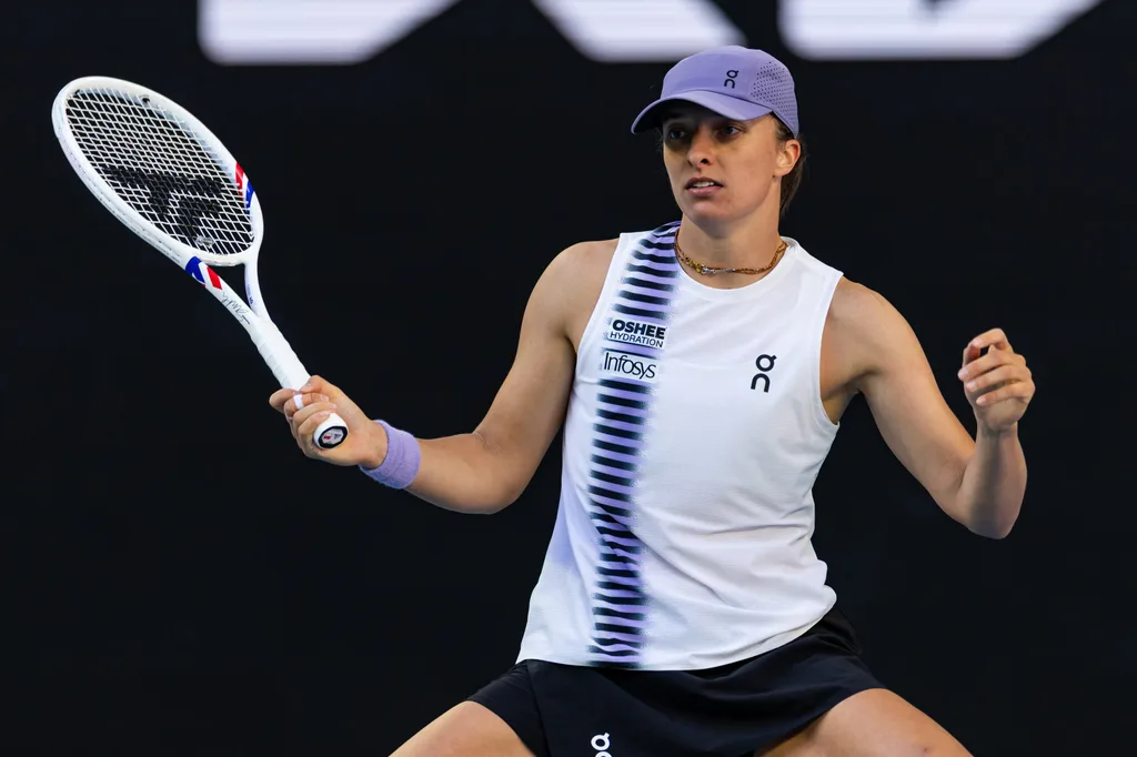 Jan 22, 2026; Melbourne, Victoria, Australia; Iga Swiatek of Poland in action against Marie Bouzkova of Czech Republic in the second round of the womenís singles at the Australian Open at John Cain Arena in Melbourne Park. Mandatory Credit: Mike Frey-Imagn Images