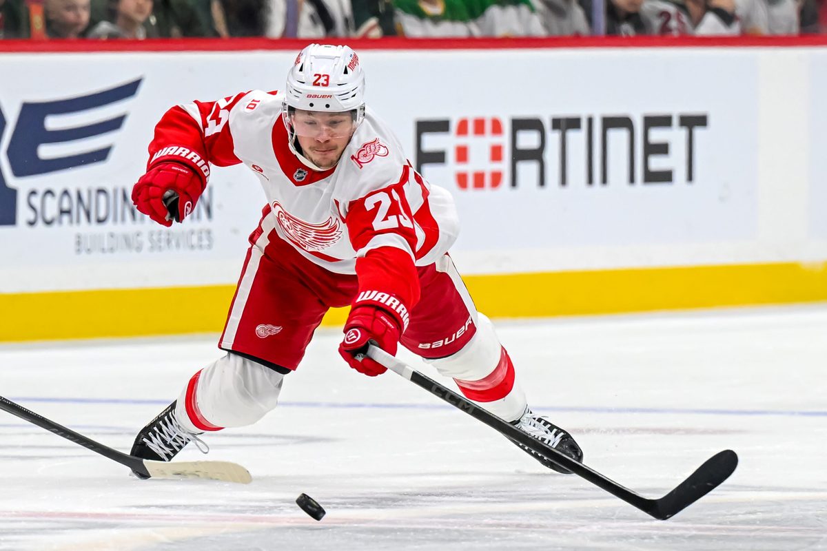 Jan 22, 2026; Saint Paul, Minnesota, USA; Detroit Red Wings forward Lucas Raymond (23) dives to advance the puck against the Minnesota Wild during the third period at Grand Casino Arena. Mandatory Credit: Nick Wosika-Imagn Images