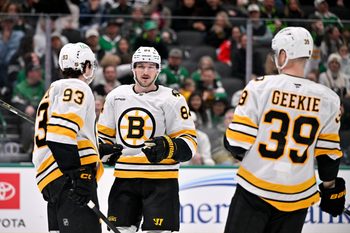 Jan 20, 2026; Dallas, Texas, USA;  Boston Bruins center Fraser Minten (93) and left wing Tanner Jeannot (84) and center Morgan Geekie (39) celebrates a goal scored against the Dallas Stars during the game at the American Airlines Center. Mandatory Credit: Jerome Miron-Imagn Images