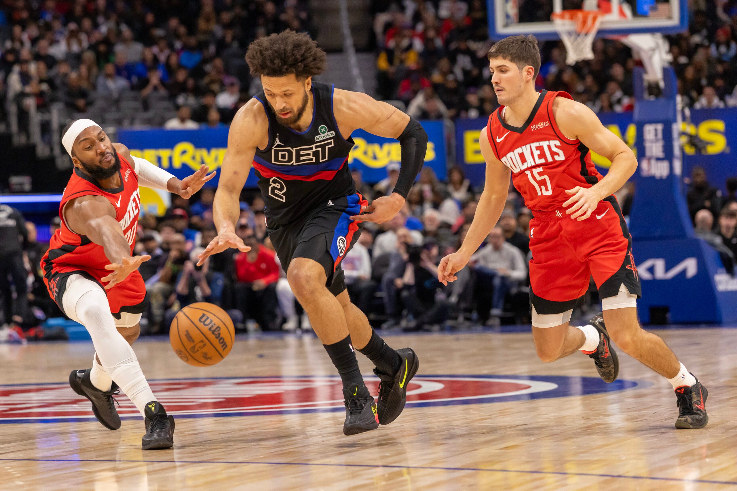 Jan 23, 2026; Detroit, Michigan, USA; Detroit Pistons guard Cade Cunningham (2) moves the ball up court between Houston Rockets center Clint Capela (30) and guard Reed Sheppard (15) during the second half at Little Caesars Arena. Mandatory Credit: David Reginek-Imagn Images