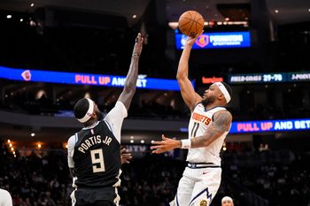 Jan 23, 2026; Milwaukee, Wisconsin, USA;  Denver Nuggets guard Bruce Brown (11) shoots over Milwaukee Bucks forward Bobby Portis (9) during the fourth quarter at Fiserv Forum. Mandatory Credit: Jeff Hanisch-Imagn Images