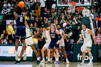 Jan 23, 2026; Fort Collins, Colorado, USA; Utah State Aggies guard MJ Collins Jr. (2) attempts a shot against Colorado State Rams guard Josh Pascarelli (1) as forward Karson Templin (22) and forward Garry Clark (11) and forward Kyle Jorgensen (35) and guard Rashaan Mbemba (21) and guard Brandon Rechsteiner (2) look on in the second half at Moby Arena. Mandatory Credit: Isaiah J. Downing-Imagn Images