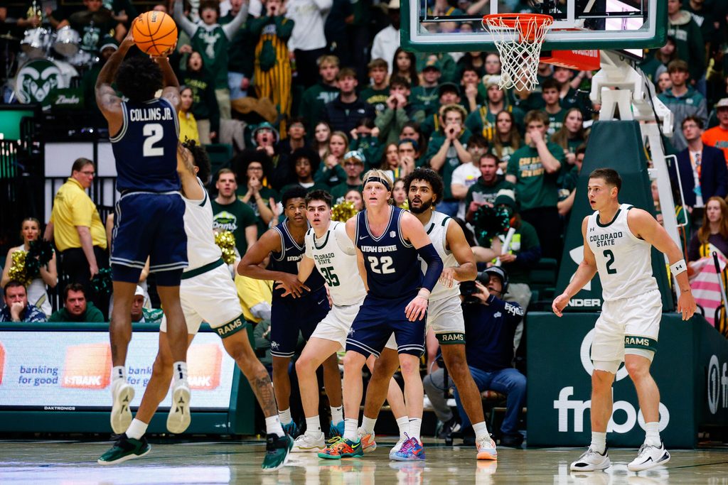 Jan 23, 2026; Fort Collins, Colorado, USA; Utah State Aggies guard MJ Collins Jr. (2) attempts a shot against Colorado State Rams guard Josh Pascarelli (1) as forward Karson Templin (22) and forward Garry Clark (11) and forward Kyle Jorgensen (35) and guard Rashaan Mbemba (21) and guard Brandon Rechsteiner (2) look on in the second half at Moby Arena. Mandatory Credit: Isaiah J. Downing-Imagn Images