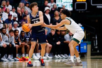 Jan 23, 2026; Fort Collins, Colorado, USA; Utah State Aggies guard Mason Falslev (12) controls the ball as Colorado State Rams guard Jase Butler (4) guards in the second half at Moby Arena. Mandatory Credit: Isaiah J. Downing-Imagn Images