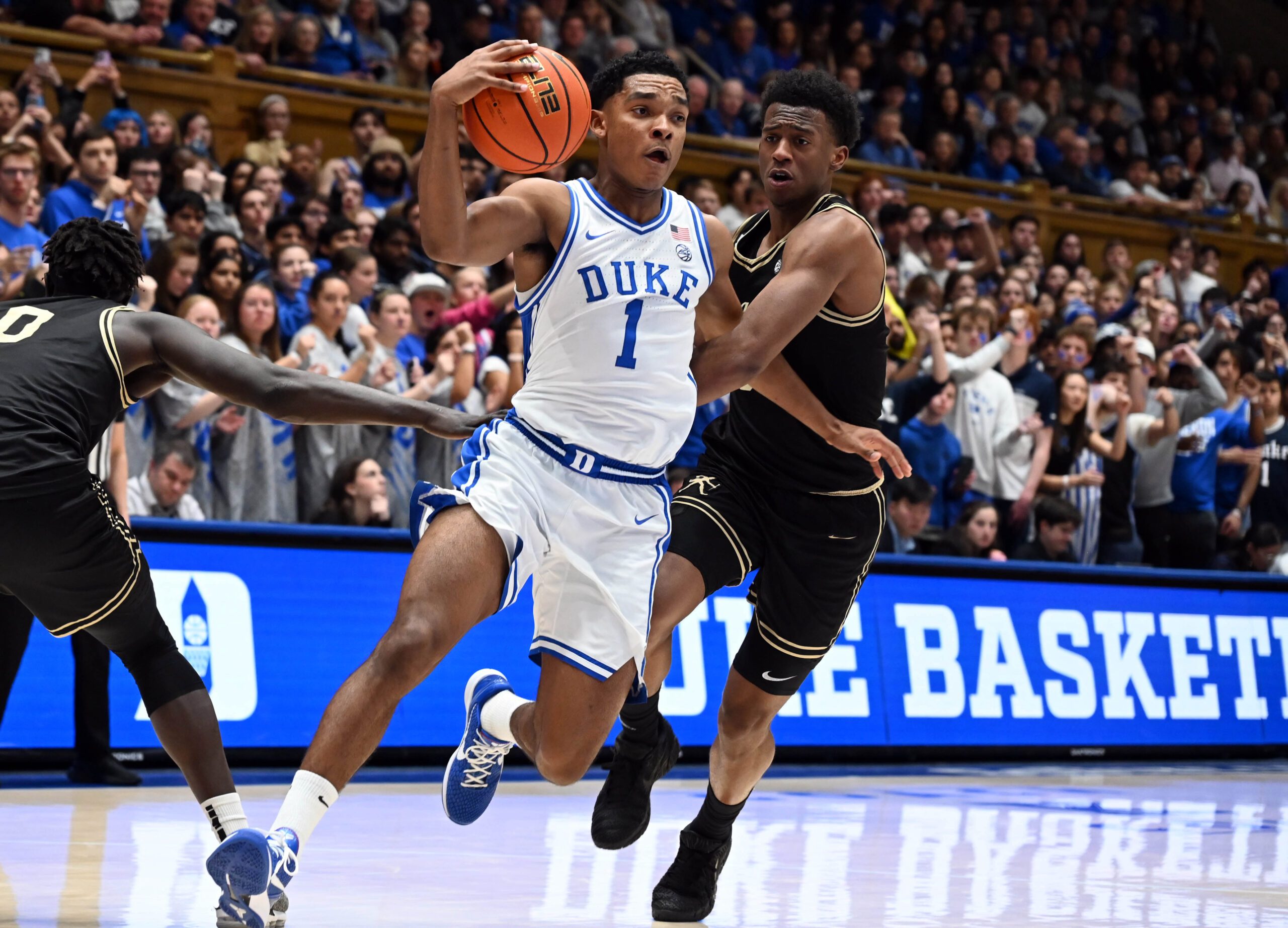 Jan 24, 2026; Durham, North Carolina, USA; Duke Blue Devils guard Caleb Foster (1) drives to the basket as Wake Forest Demon Deacons guard Myles Colvin (6) defends during the second half at Cameron Indoor Stadium. Mandatory Credit: Rob Kinnan-Imagn Images