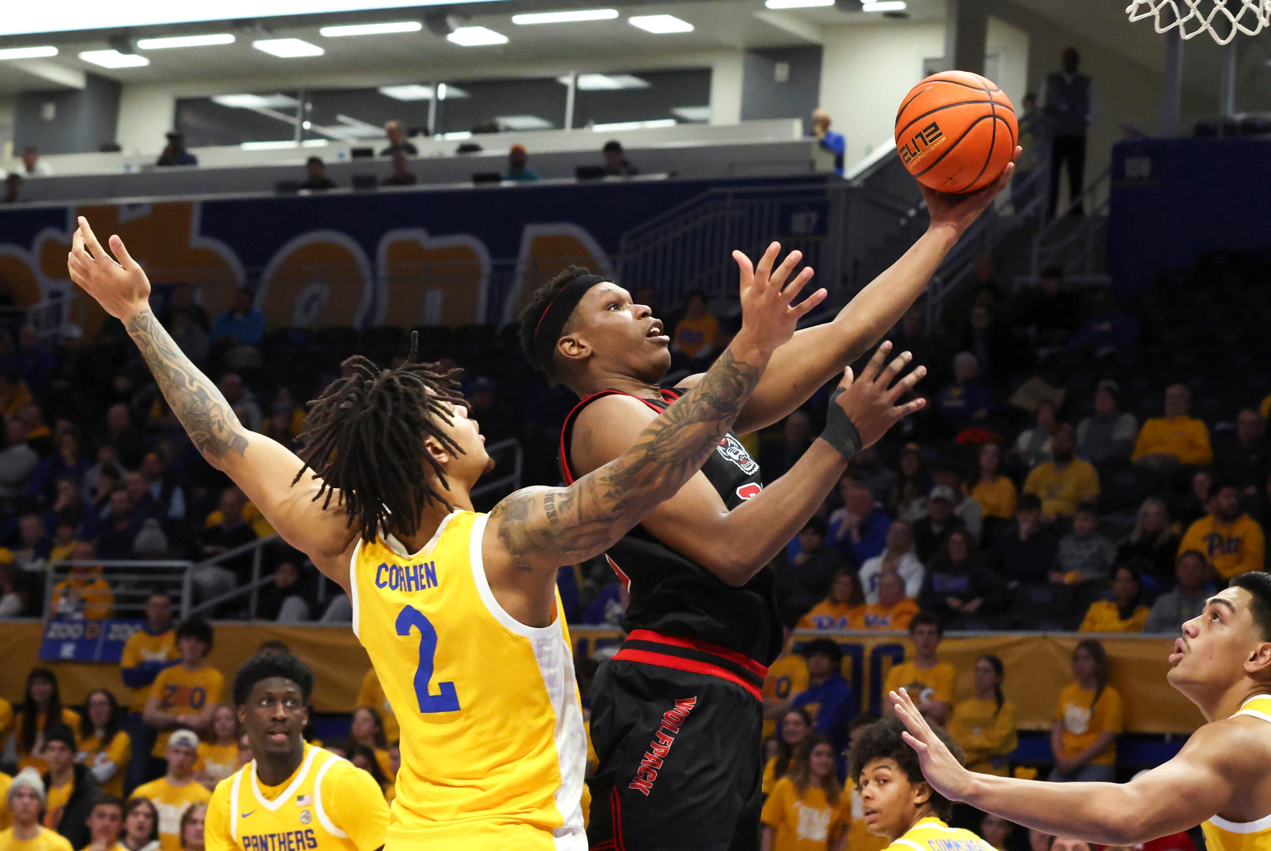 Jan 24, 2026; Pittsburgh, Pennsylvania, USA;  NC State Wolfpack forward Ven-Allen Lubin (right) goes to the basket against Pittsburgh Panthers forward Cameron Corhen (2) during the second half at the Petersen Events Center. Mandatory Credit: Charles LeClaire-Imagn Images