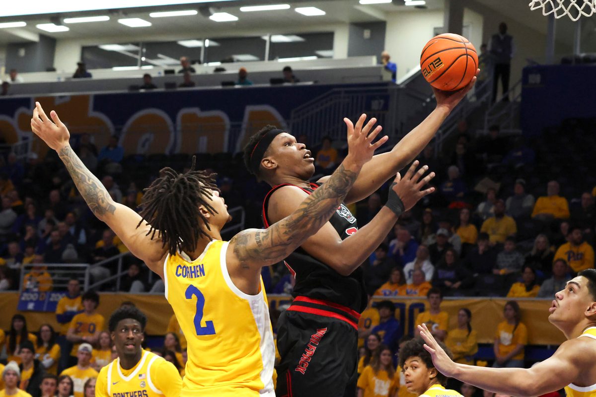 Jan 24, 2026; Pittsburgh, Pennsylvania, USA; NC State Wolfpack forward Ven-Allen Lubin (right) goes to the basket against Pittsburgh Panthers forward Cameron Corhen (2) during the second half at the Petersen Events Center. Mandatory Credit: Charles LeClaire-Imagn Images