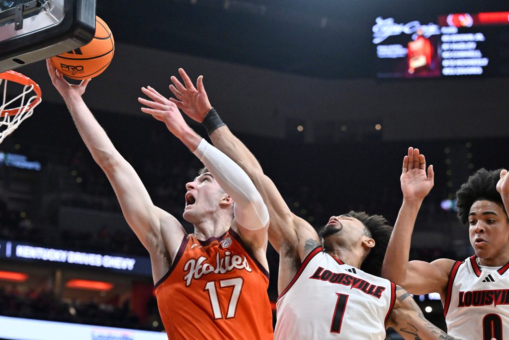 Jan 24, 2026; Louisville, Kentucky, USA; Virginia Tech Hokies guard Neoklis Avdalas (17) shoots against Louisville Cardinals guard J'vonne Hadley (1) and guard Mikel Brown Jr. (0) during the first half at KFC Yum! Center. Mandatory Credit: Jamie Rhodes-Imagn Images