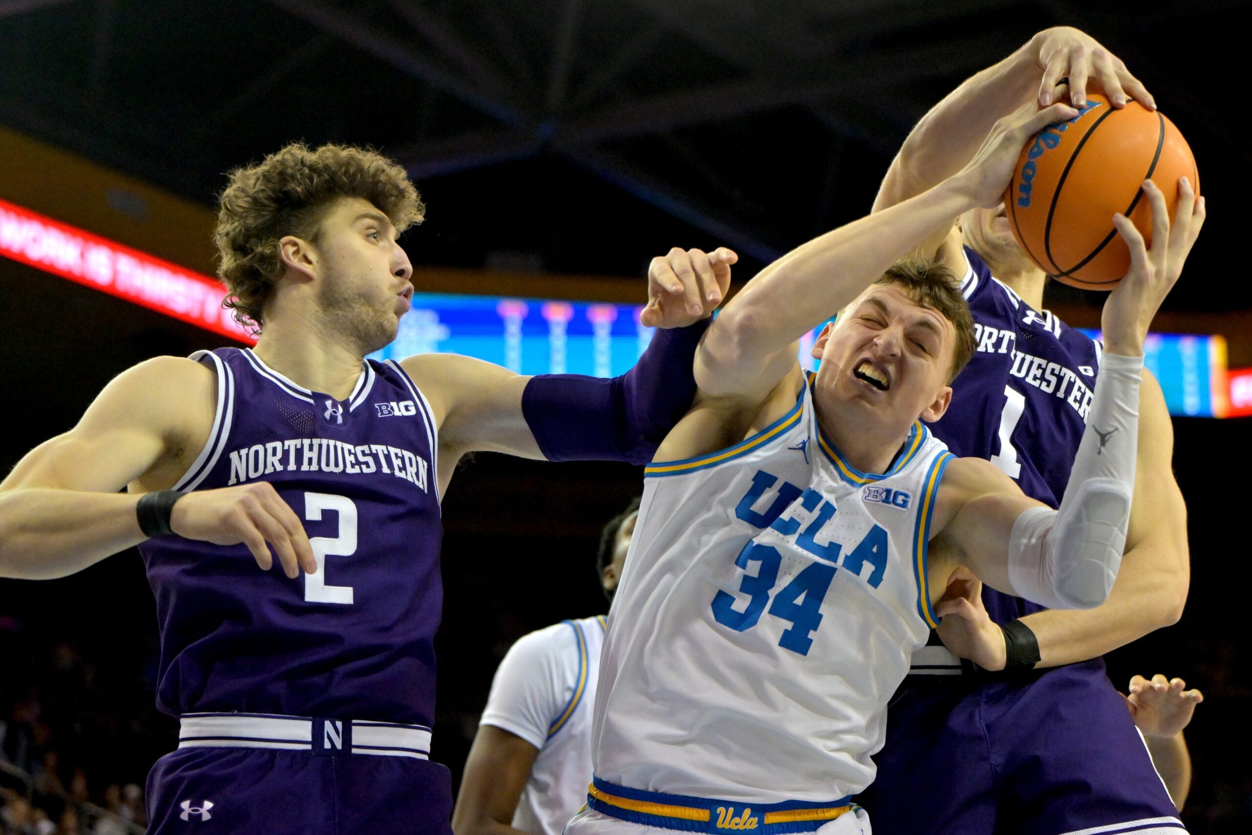 Jan 24, 2026; Los Angeles, California, USA;  Northwestern Wildcats forward Nick Martinelli (2) and forward Tyler Kropp (1) defend UCLA Bruins forward Tyler Bilodeau (34) in the first half at Pauley Pavilion presented by Wescom Financial. Mandatory Credit: Jayne Kamin-Oncea-Imagn Images