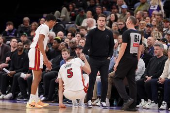 Jan 24, 2026; Salt Lake City, Utah, USA;  Utah Jazz Head Coach Will Hardy helps Miami Heat forward Nikola Jović (5) up off of the floor during the second half at Delta Center. Mandatory Credit: Chris Nicoll-Imagn Images