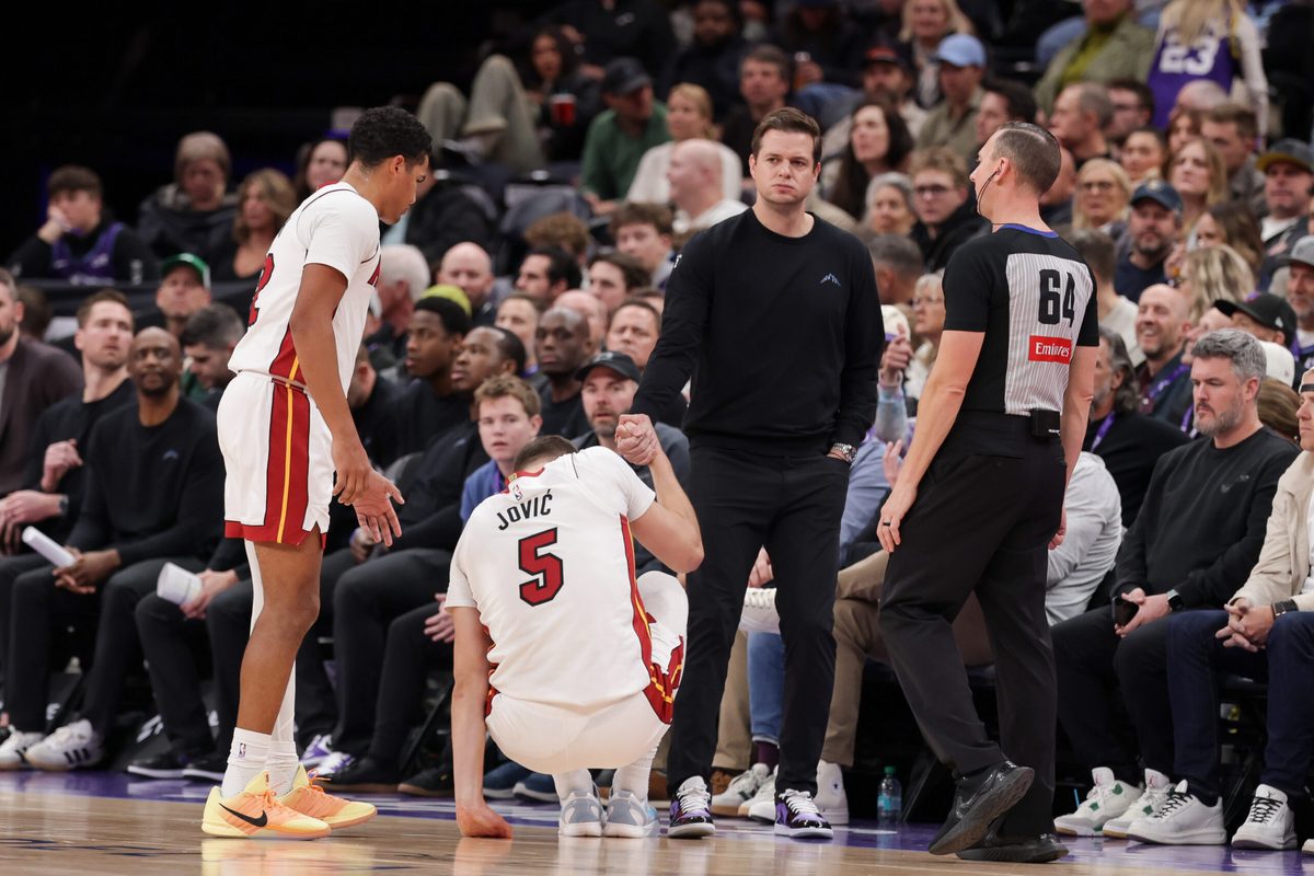 Jan 24, 2026; Salt Lake City, Utah, USA; Utah Jazz Head Coach Will Hardy helps Miami Heat forward Nikola Jović (5) up off of the floor during the second half at Delta Center. Mandatory Credit: Chris Nicoll-Imagn Images