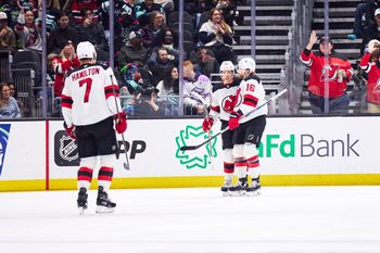 Jan 25, 2026; Seattle, Washington, USA; New Jersey Devils center Jack Hughes (86) celebrates with New Jersey Devils right wing Connor Brown (16) after scoring a goal during the third period against the Seattle Kraken at Climate Pledge Arena. Mandatory Credit: Blake Dahlin-Imagn Images