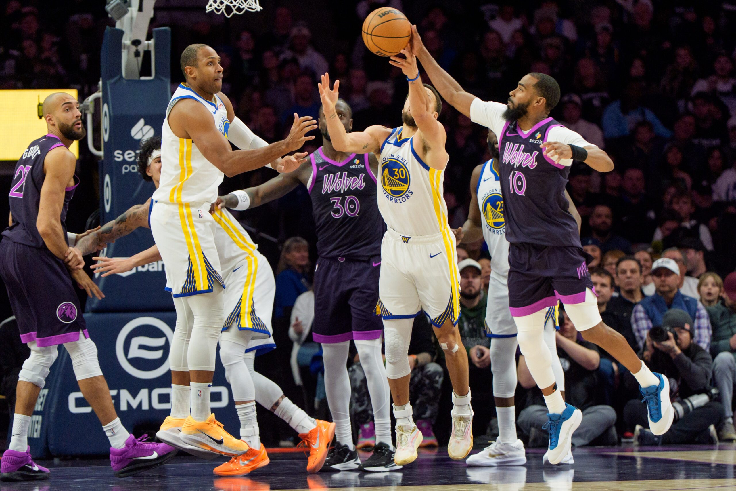 Jan 25, 2026; Minneapolis, Minnesota, USA; Minnesota Timberwolves guard Mike Conley (10) knocks a rebound out of the hands of Golden State Warriors guard Stephen Curry (30) in the fourth quarter at Target Center. Mandatory Credit: Matt Blewett-Imagn Images