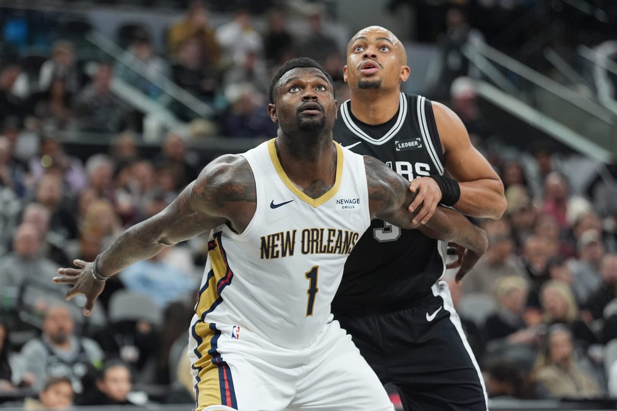 Jan 25, 2026; San Antonio, Texas, USA;  New Orleans Pelicans forward Zion Williamson (1) and San Antonio Spurs forward Keldon Johnson (3) looks up for a rebound in the first at Frost Bank Center. Mandatory Credit: Daniel Dunn-Imagn Images
