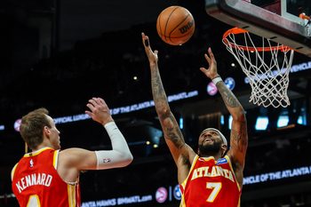 Jan 26, 2026; Atlanta, Georgia, USA; Atlanta Hawks guard Luke Kennard (4) and Atlanta Hawks guard Nickeil Alexander-Walker (7) jump for a rebound against the Indiana Pacers during the third quarter at State Farm Arena. Mandatory Credit: Jordan Godfree-Imagn Images