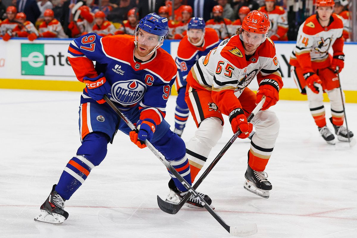 Jan 26, 2026; Edmonton, Alberta, CAN; Edmonton Oilers forward Connor McDavid (97) and Anaheim Ducks defensemen Jacob Trouba (65) look for a loose puck during the first period at Rogers Place. Mandatory Credit: Perry Nelson-Imagn Images
