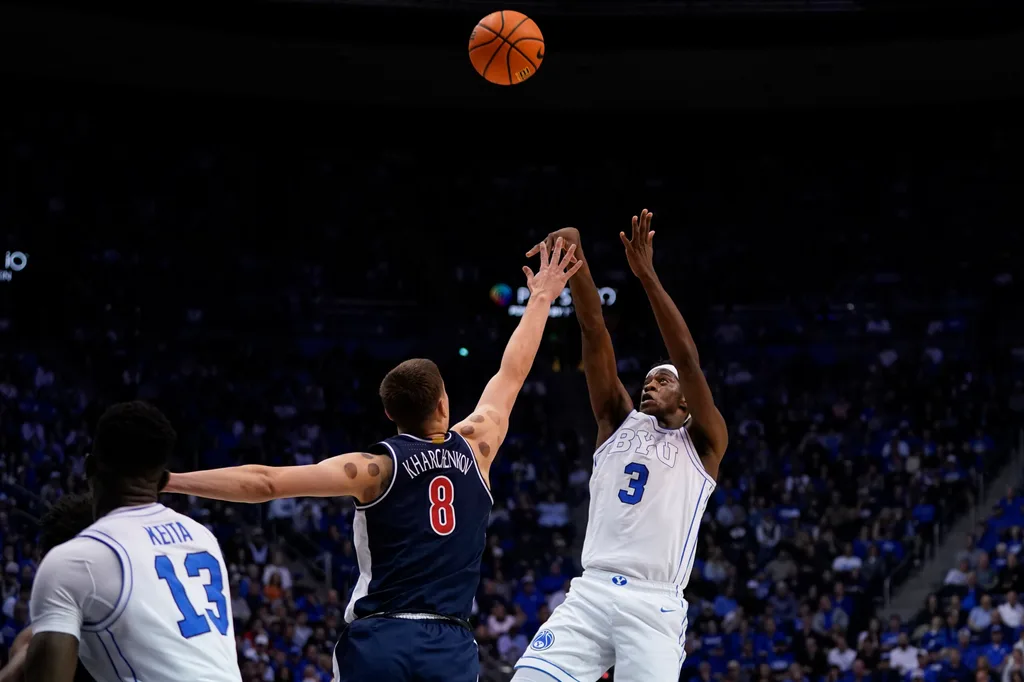 Jan 26, 2026; Provo, Utah, USA; BYU Cougars forward AJ Dybantsa (3) shoots the ball while being defended by Arizona Wildcats forward Ivan Kharchenkov (8) during the first half at Marriott Center. Mandatory Credit: Aaron Baker-Imagn Images
