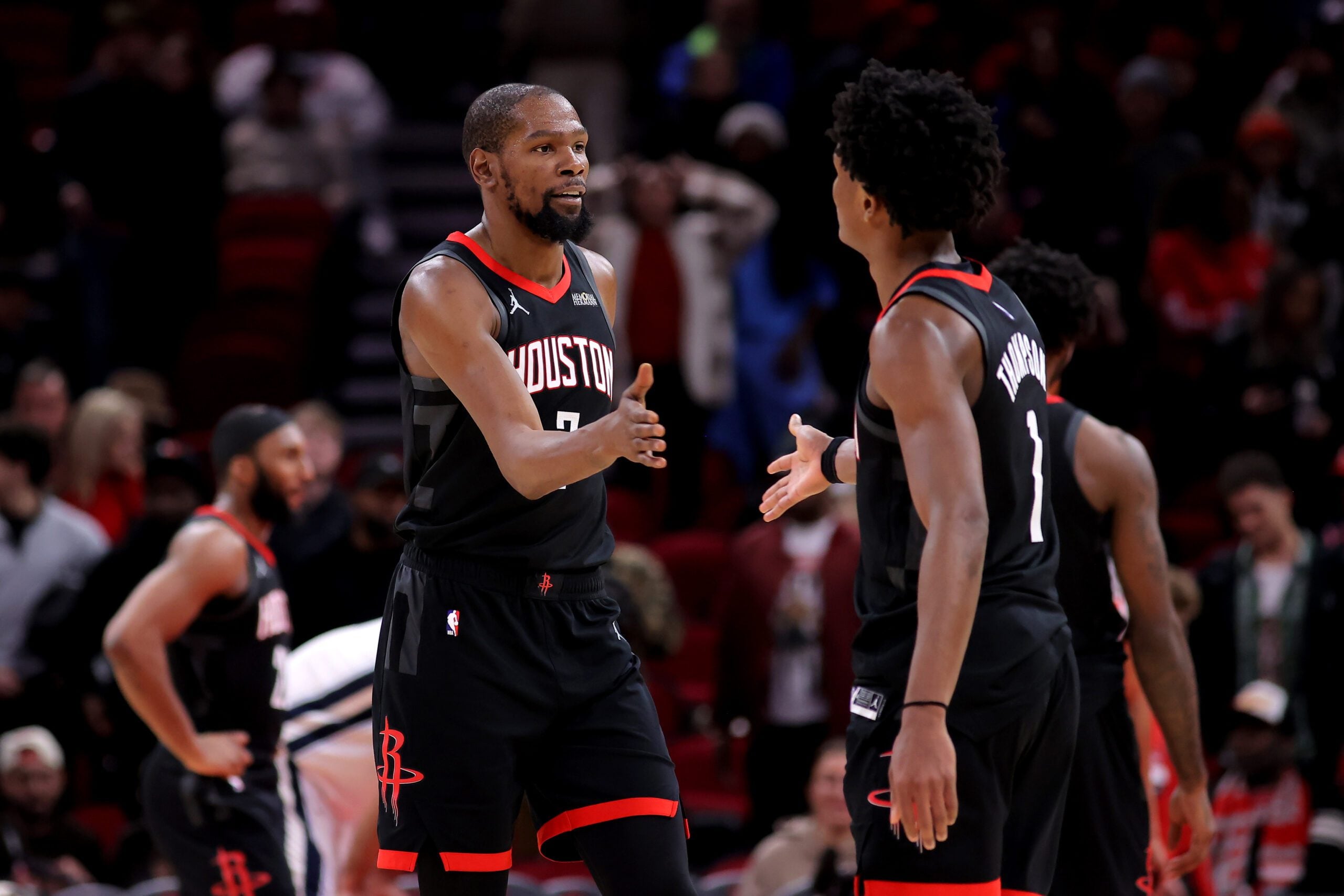 Jan 26, 2026; Houston, Texas, USA; Houston Rockets forward Kevin Durant (7) is congratulated by Houston Rockets guard Amen Thompson (1) against the Memphis Grizzlies during the fourth quarter at Toyota Center. Mandatory Credit: Erik Williams-Imagn Images