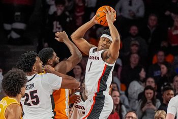 Jan 28, 2026; Athens, Georgia, USA; Georgia Bulldogs forward Kareem Stagg (1) grabs a rebound over Tennessee Volunteers forward Jaylen Carey (23) during the first half at Stegeman Coliseum. Mandatory Credit: Dale Zanine-Imagn Images
