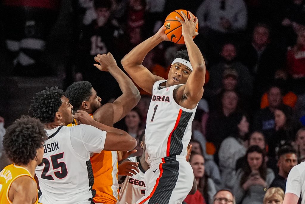 Jan 28, 2026; Athens, Georgia, USA; Georgia Bulldogs forward Kareem Stagg (1) grabs a rebound over Tennessee Volunteers forward Jaylen Carey (23) during the first half at Stegeman Coliseum. Mandatory Credit: Dale Zanine-Imagn Images