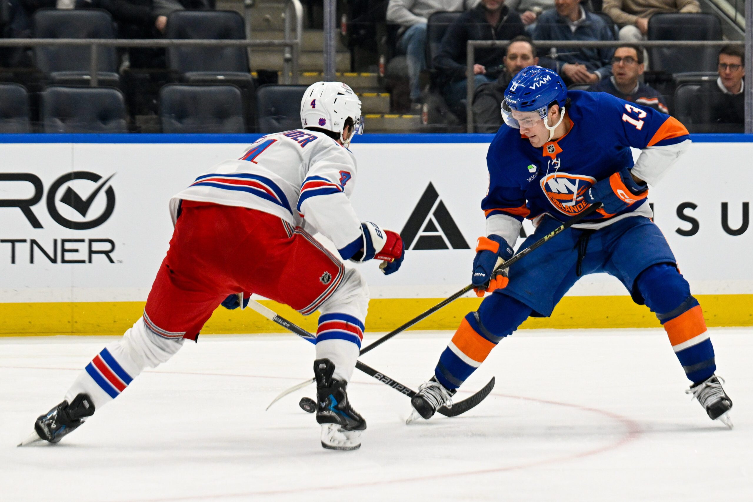 Jan 28, 2026; Elmont, New York, USA;  New York Rangers defenseman Braden Schneider (4) defends against New York Islanders center Mathew Barzal (13) during the second period at UBS Arena. Mandatory Credit: Dennis Schneidler-Imagn Images