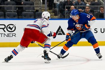 Jan 28, 2026; Elmont, New York, USA;  New York Rangers defenseman Braden Schneider (4) defends against New York Islanders center Mathew Barzal (13) during the second period at UBS Arena. Mandatory Credit: Dennis Schneidler-Imagn Images