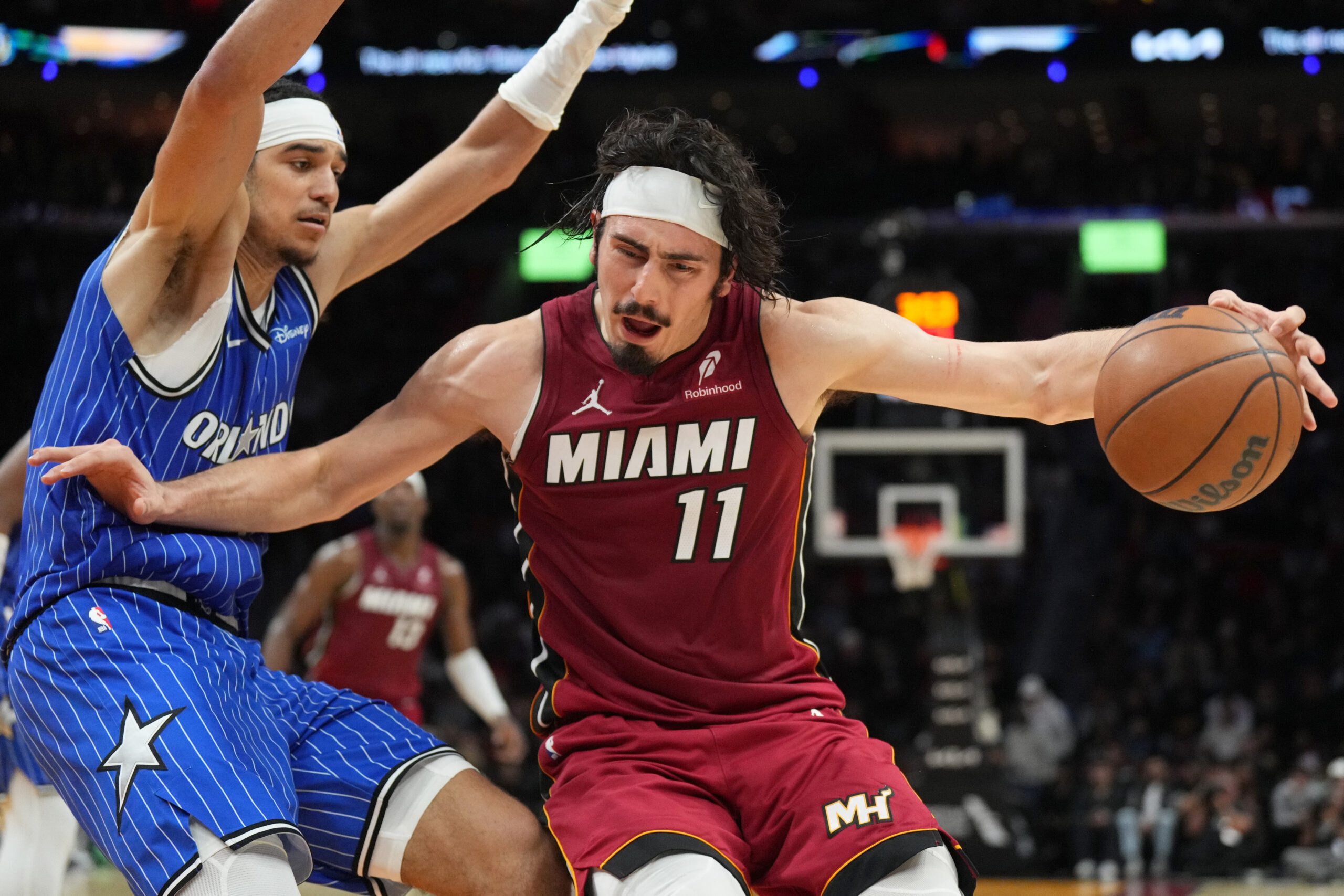 Jan 28, 2026; Miami, Florida, USA;  Miami Heat forward Jaime Jaquez Jr. (11) tries to drive past Orlando Magic guard Anthony Black (0) during the second half at Kaseya Center. Mandatory Credit: Jim Rassol-Imagn Images
