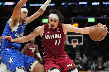 Jan 28, 2026; Miami, Florida, USA;  Miami Heat forward Jaime Jaquez Jr. (11) tries to drive past Orlando Magic guard Anthony Black (0) during the second half at Kaseya Center. Mandatory Credit: Jim Rassol-Imagn Images