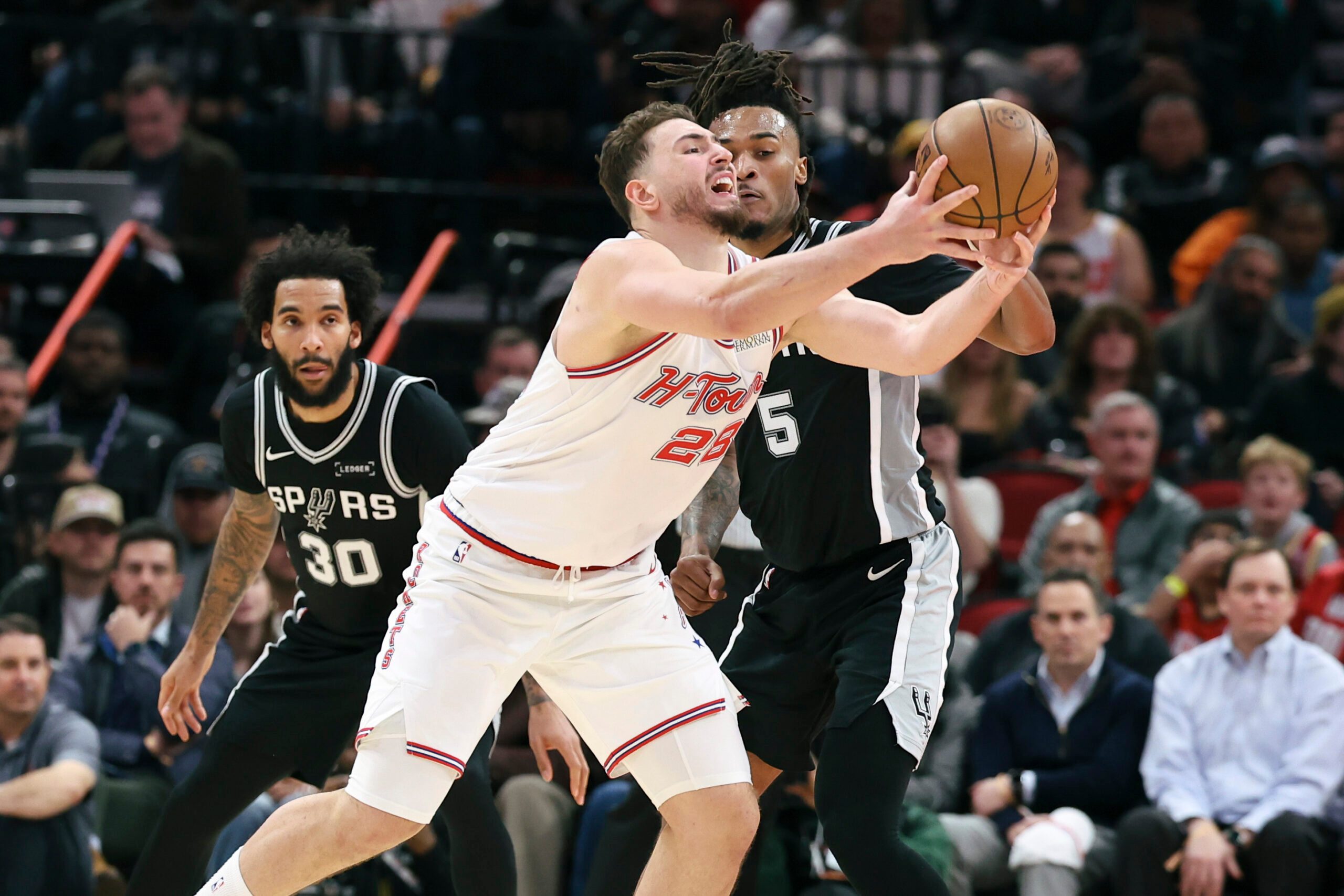 Jan 28, 2026; Houston, Texas, USA; San Antonio Spurs guard Stephon Castle (5) defends as Houston Rockets center Alperen Sengun (28) attempts to control the ball during the fourth quarter at Toyota Center. Mandatory Credit: Troy Taormina-Imagn Images